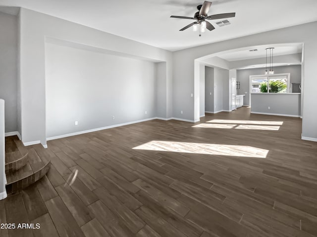 unfurnished living room featuring ceiling fan and dark hardwood / wood-style floors