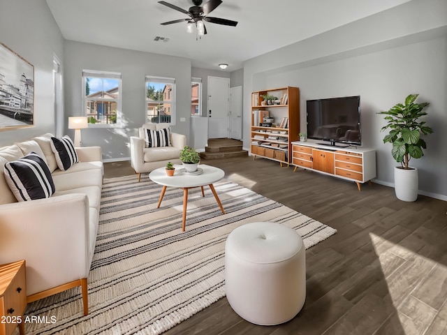 living room featuring dark hardwood / wood-style flooring and ceiling fan