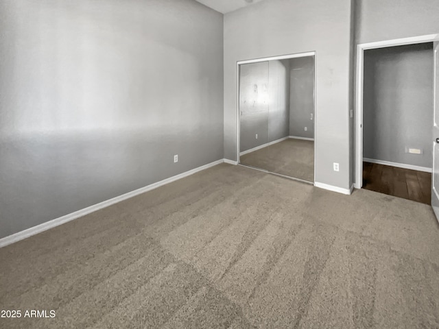 unfurnished bedroom with a closet and carpet floors