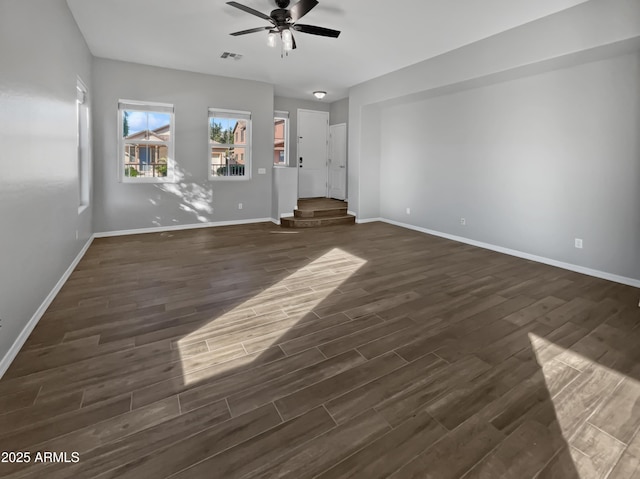 unfurnished living room featuring ceiling fan and dark wood-type flooring