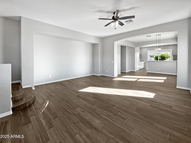 unfurnished living room featuring ceiling fan and dark wood-type flooring