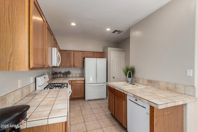 9511 E Kiva Ave, Mesa, AZ 85209 - kitchen with white appliances, tile countertops, a sink, recessed lighting, and light tile patterned floors