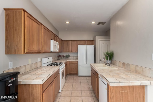 9511 E Kiva Ave, Mesa, AZ 85209 - kitchen with white appliances, tile counters, a sink, recessed lighting, and light tile patterned flooring