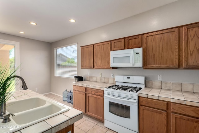 9511 E Kiva Ave, Mesa, AZ 85209 - kitchen with white appliances, tile countertops, a sink, brown cabinets, and recessed lighting
