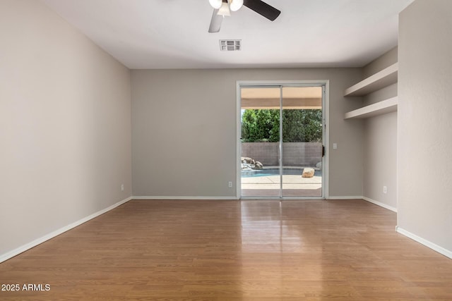 9511 E Kiva Ave, Mesa, AZ 85209 - empty room with a ceiling fan, wood finished floors, and baseboards