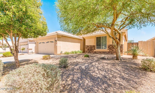 9511 E Kiva Ave, Mesa, AZ 85209 - view of front facade featuring stucco siding, a garage, concrete driveway, and stone siding