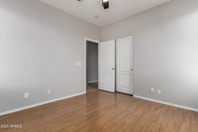 9511 E Kiva Ave, Mesa, AZ 85209 - unfurnished bedroom featuring baseboards, wood finished floors, and a ceiling fan