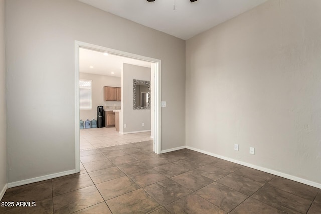9511 E Kiva Ave, Mesa, AZ 85209 - empty room featuring ceiling fan, dark tile patterned floors, and baseboards