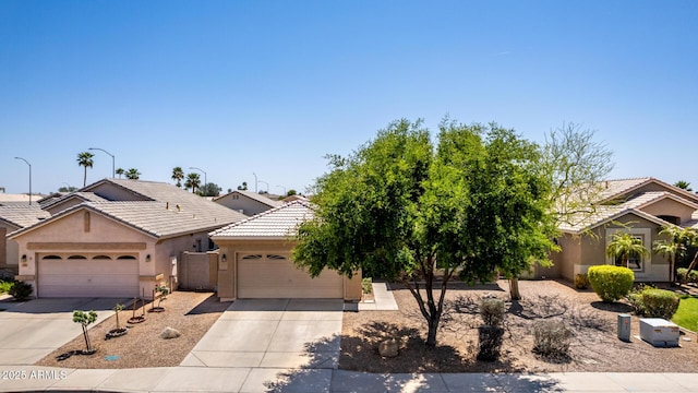 9511 E Kiva Ave, Mesa, AZ 85209 - view of front of home with an attached garage, stucco siding, driveway, and a tile roof