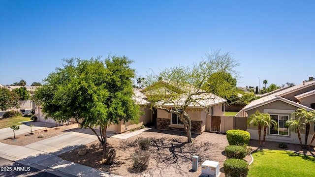 9511 E Kiva Ave, Mesa, AZ 85209 - view of property hidden behind natural elements with concrete driveway and stucco siding