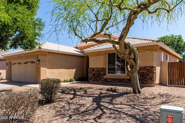9511 E Kiva Ave, Mesa, AZ 85209 - view of front of house featuring stucco siding, stone siding, a tiled roof, an attached garage, and driveway
