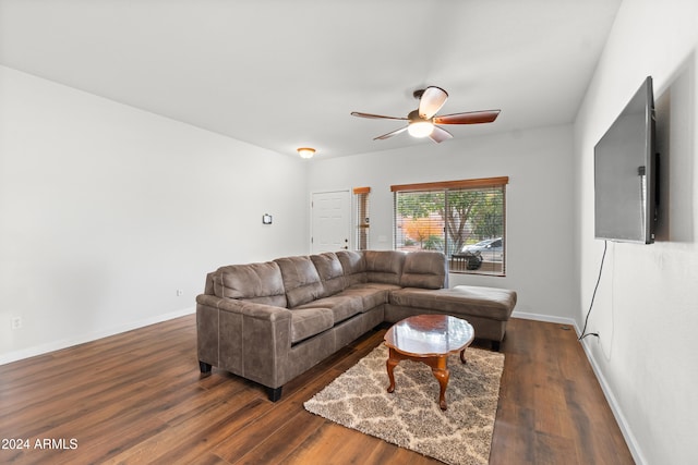 living room featuring dark hardwood / wood-style flooring and ceiling fan