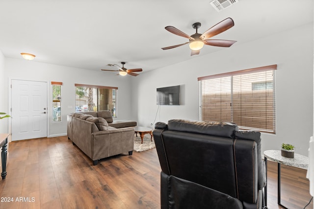 living room featuring dark hardwood / wood-style floors and ceiling fan