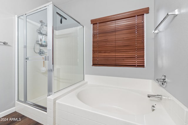 bathroom featuring independent shower and bath and hardwood / wood-style flooring