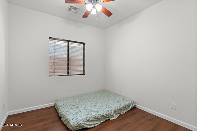 bedroom featuring ceiling fan and dark wood-type flooring