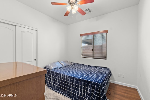 bedroom with wood-type flooring, a closet, and ceiling fan