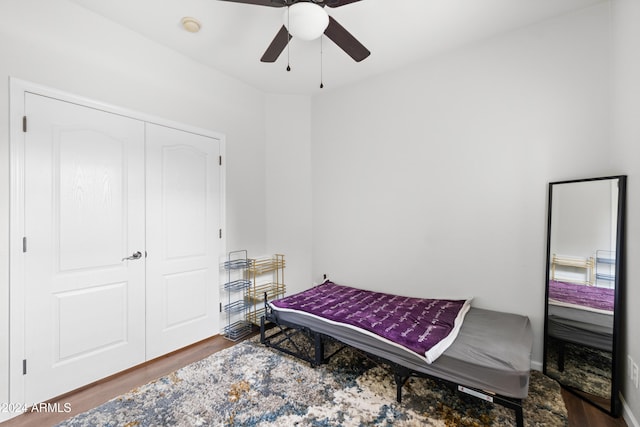 bedroom with hardwood / wood-style floors, a closet, and ceiling fan