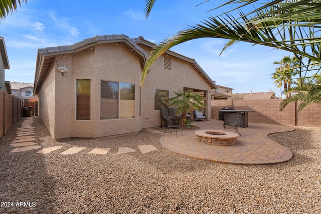 back of house featuring a patio and an outdoor fire pit