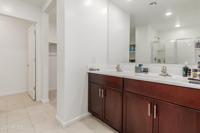 bathroom featuring vanity, tile patterned flooring, and a shower with shower door