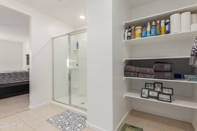 bathroom featuring an enclosed shower and tile patterned floors