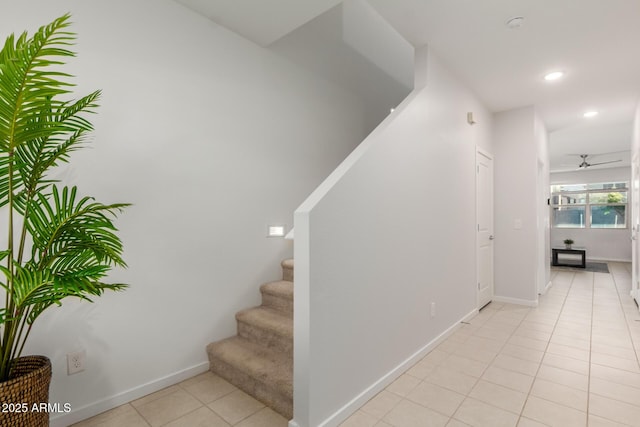 stairs with ceiling fan and tile patterned floors