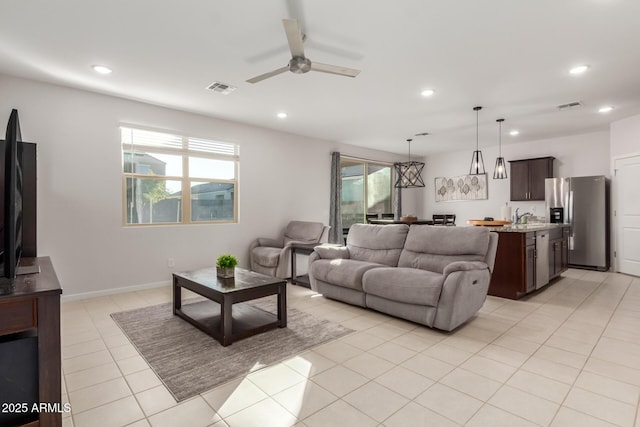 tiled living room with ceiling fan