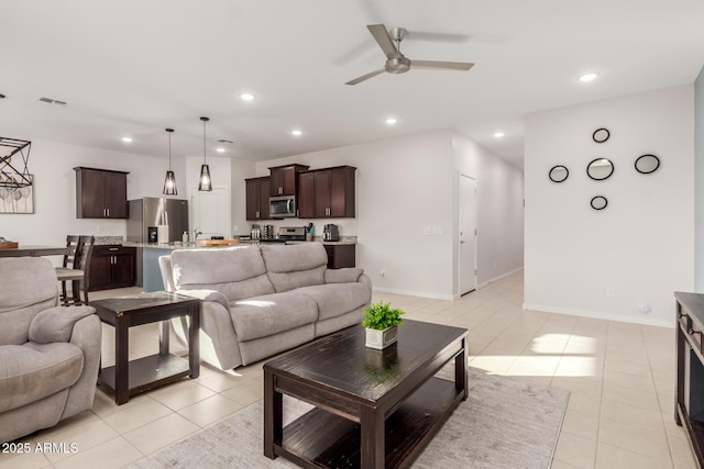 tiled living room with sink and ceiling fan