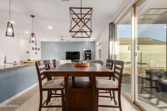 dining area featuring ceiling fan and light tile patterned flooring