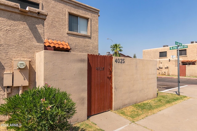 view of home's exterior with a gate and stucco siding