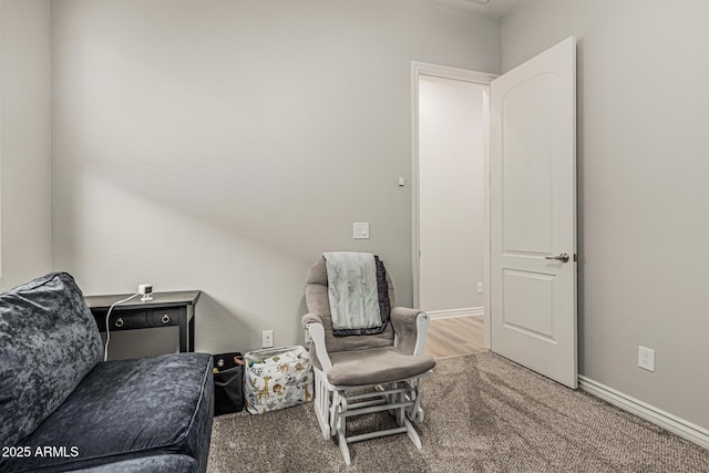 sitting room with carpet and baseboards
