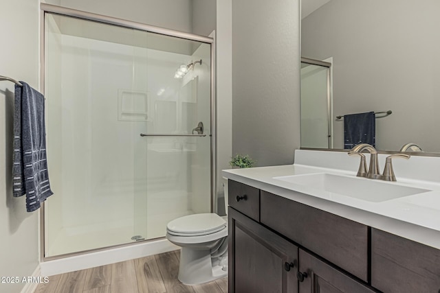 full bathroom featuring a shower stall, wood finished floors, and toilet