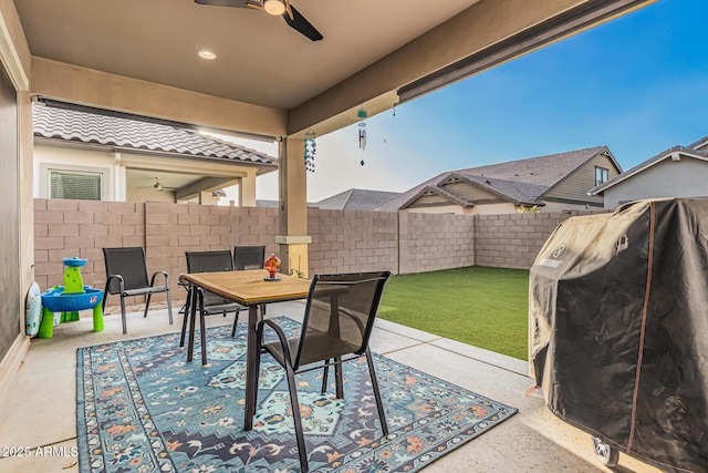 view of patio / terrace featuring a ceiling fan, a fenced backyard, and outdoor dining space