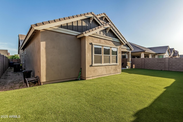 rear view of property featuring stucco siding, a tiled roof, and cooling unit