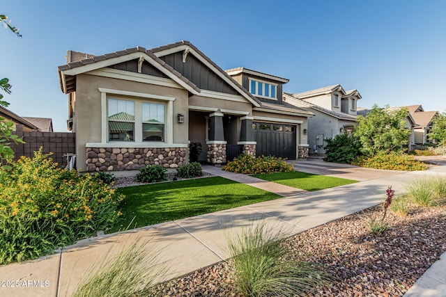 craftsman-style house with driveway, stone siding, and stucco siding