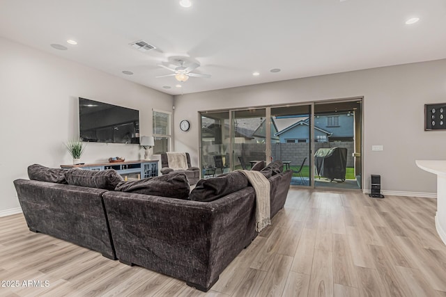 living room with light wood-type flooring, ceiling fan, baseboards, and recessed lighting
