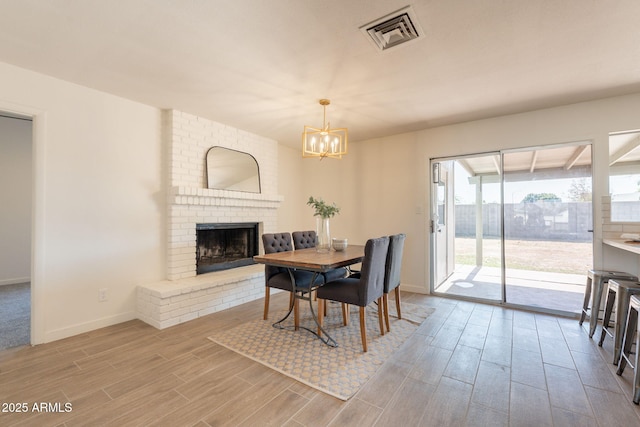 3118 S Los Altos Dr, Mesa, AZ 85202 - dining space with wood finished floors, a chandelier, baseboards, and a fireplace