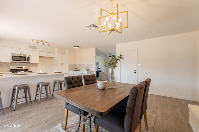 3118 S Los Altos Dr, Mesa, AZ 85202 - dining space featuring light wood-style floors, a chandelier, and baseboards