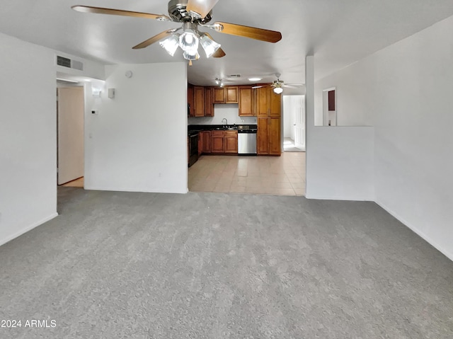 unfurnished living room with ceiling fan, sink, and light colored carpet