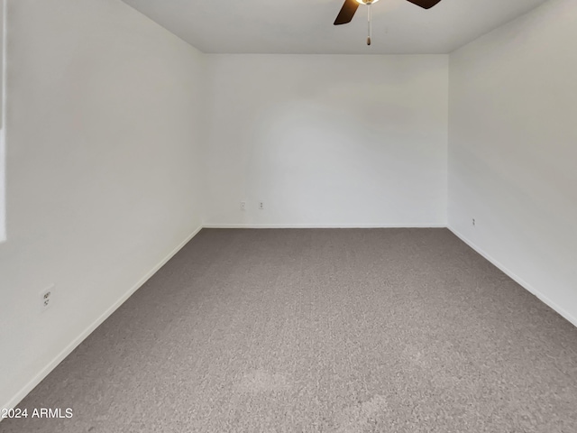 spare room with carpet and ceiling fan