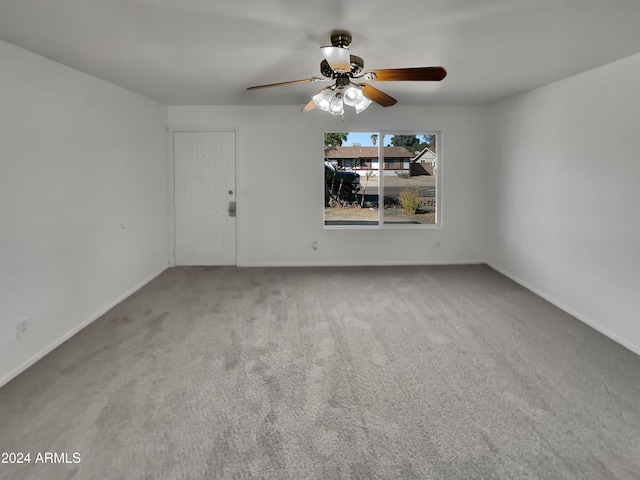 carpeted empty room featuring ceiling fan