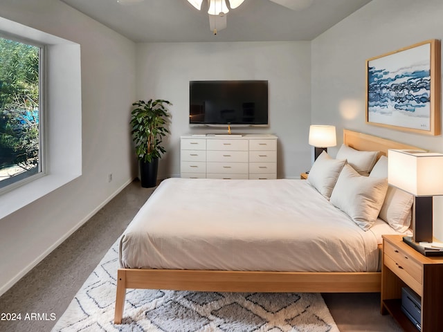 bedroom with ceiling fan and light carpet