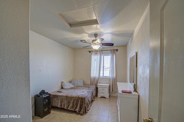 tiled bedroom featuring ceiling fan