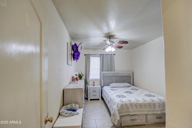 bedroom with light tile patterned floors, a textured ceiling, and ceiling fan