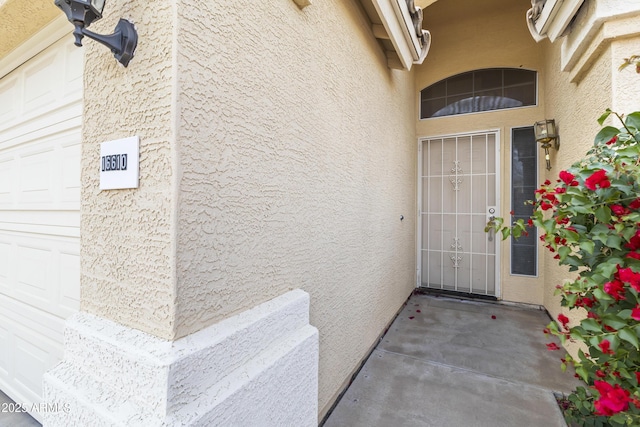 doorway to property featuring a garage