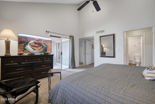 bedroom with ensuite bath, ceiling fan, a towering ceiling, light carpet, and access to outside