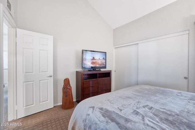 bedroom featuring high vaulted ceiling and a closet