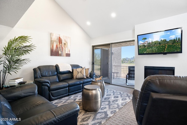 living room featuring high vaulted ceiling and carpet floors