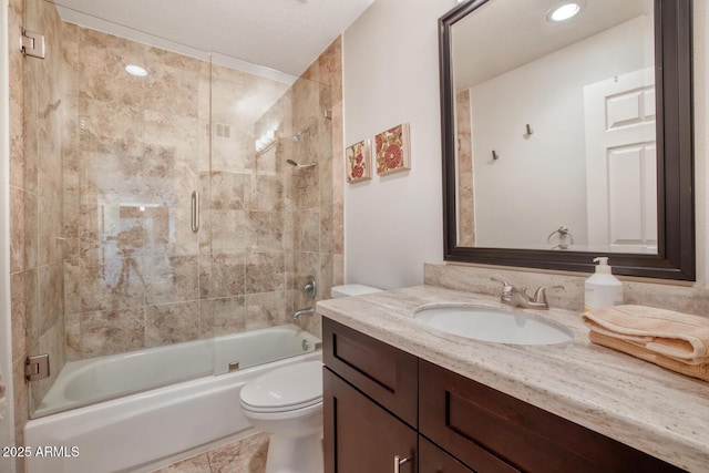 full bathroom featuring bath / shower combo with glass door, vanity, and toilet