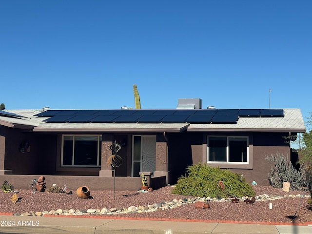 ranch-style house with solar panels