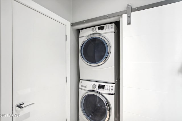 laundry room with stacked washer / dryer